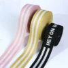 Close-up of GRS certified eco friendly recycled polyester jacquard webbing with custom woven brand logo