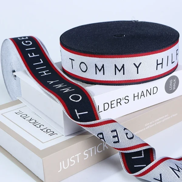 Personalized Pattern Jacquard Webbing Ribbon for trousers A fashionable canvas tote bag featuring a personalized jacquard woven ribbon as a stylish shoulder strap and decorative trim.